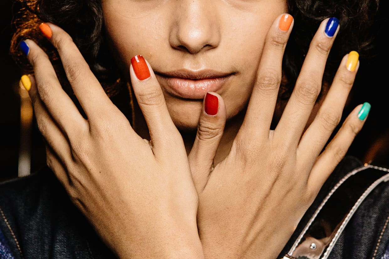 A model shows her multicolor manicure backstage at the United Colours Of Benetton show during Milan Fashion Week Autumn/Winter 2019/20, Feb. 19, 2019.