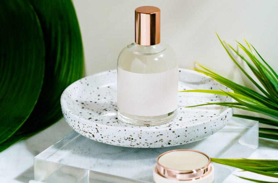 Perfume and skincare products over marble.