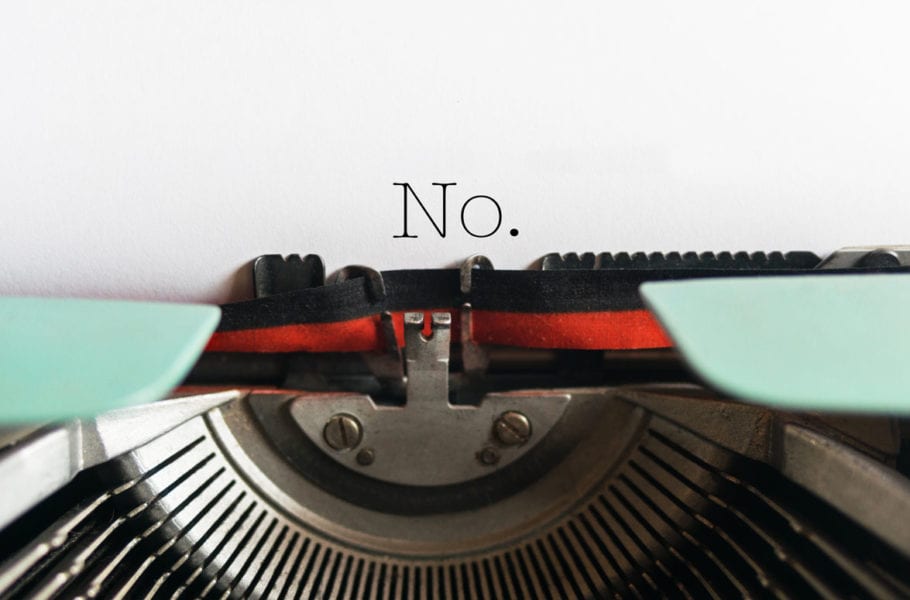 The word "No" appears on a piece of paper in a typewriter.