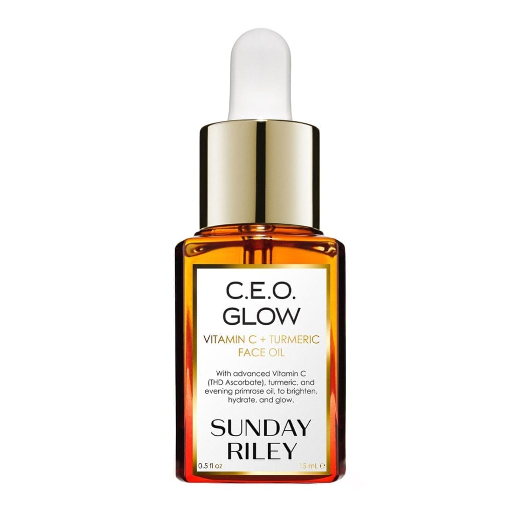 A glass bottle filled with orange oil.