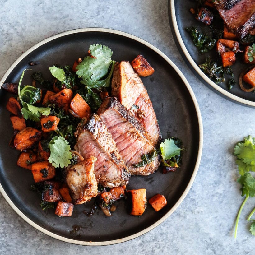 An overhead photo of steak with sweet potato hash.