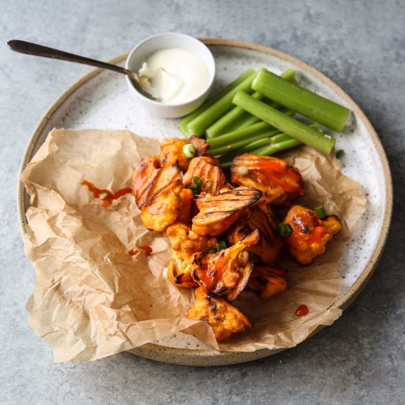 Overhead shot of gluten-free buffalo bites with celery sticks and Greek yogurt.
