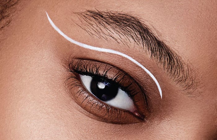 Close up of a woman's eye with a white line on the eyelid.