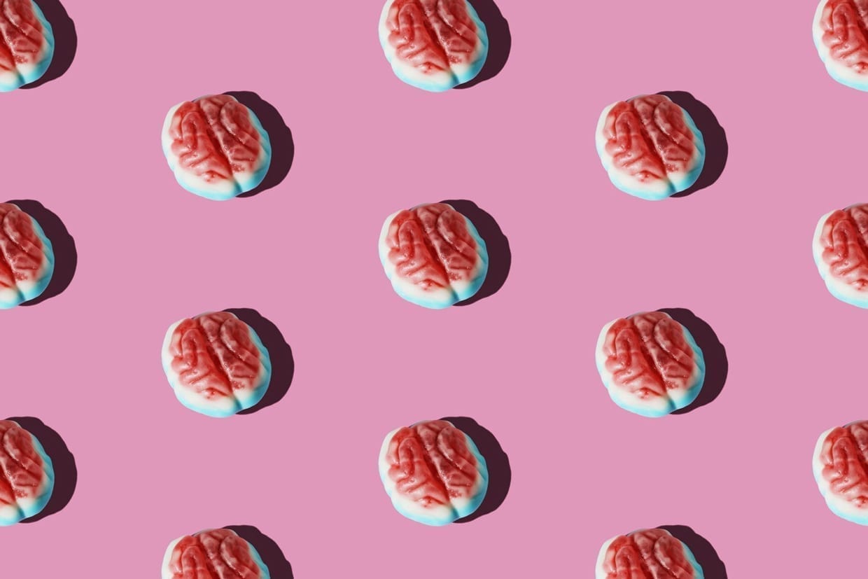 Brain candy arranged in a pattern on a pink background.