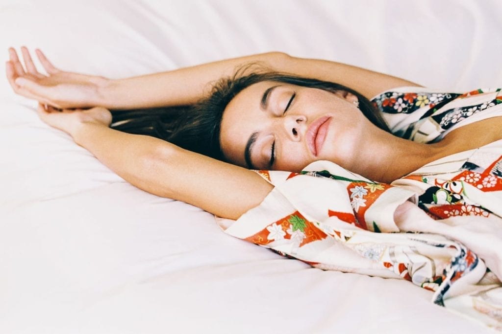 Woman sleeping on a bed.