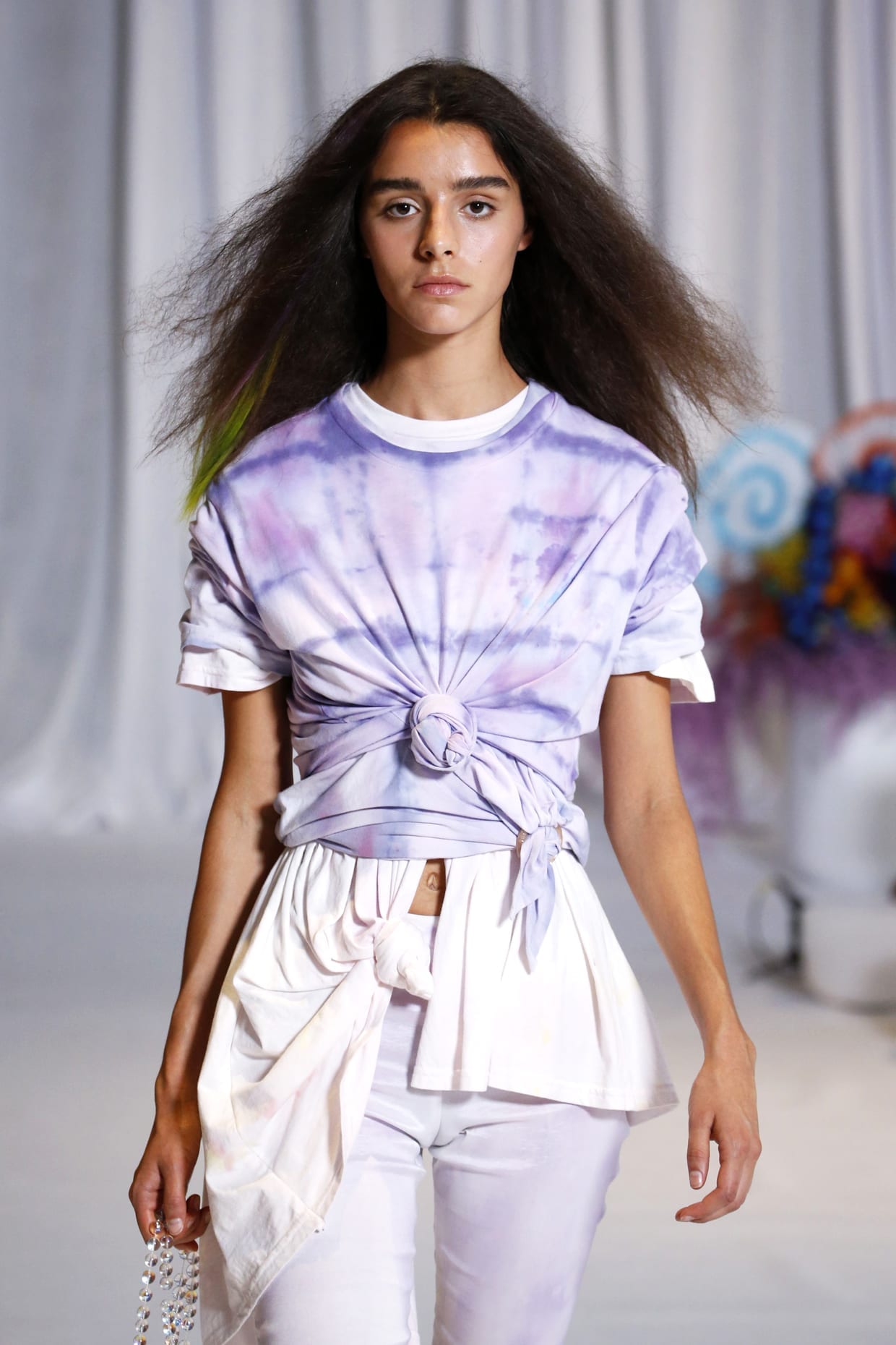A model wears a lilac tie dye shirt with white biker shorts at the Collina Strada Spring Summer fashion show.