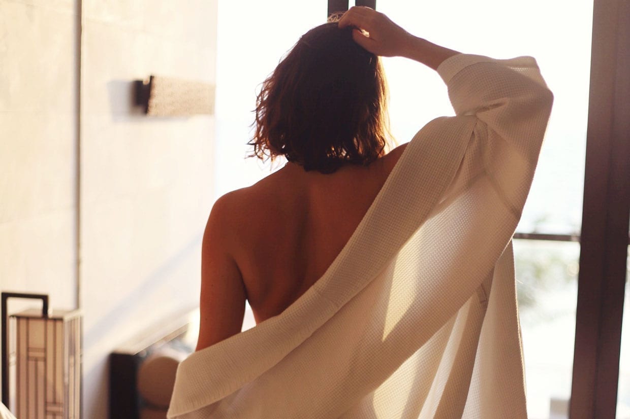 A woman with a robe on from behind.
