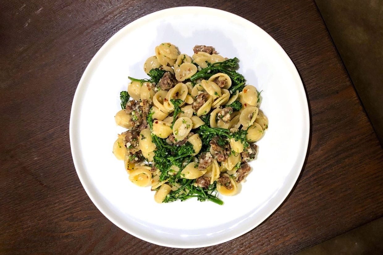 Orecchiette with Broccoli Rabe and Sausage on a white plate.