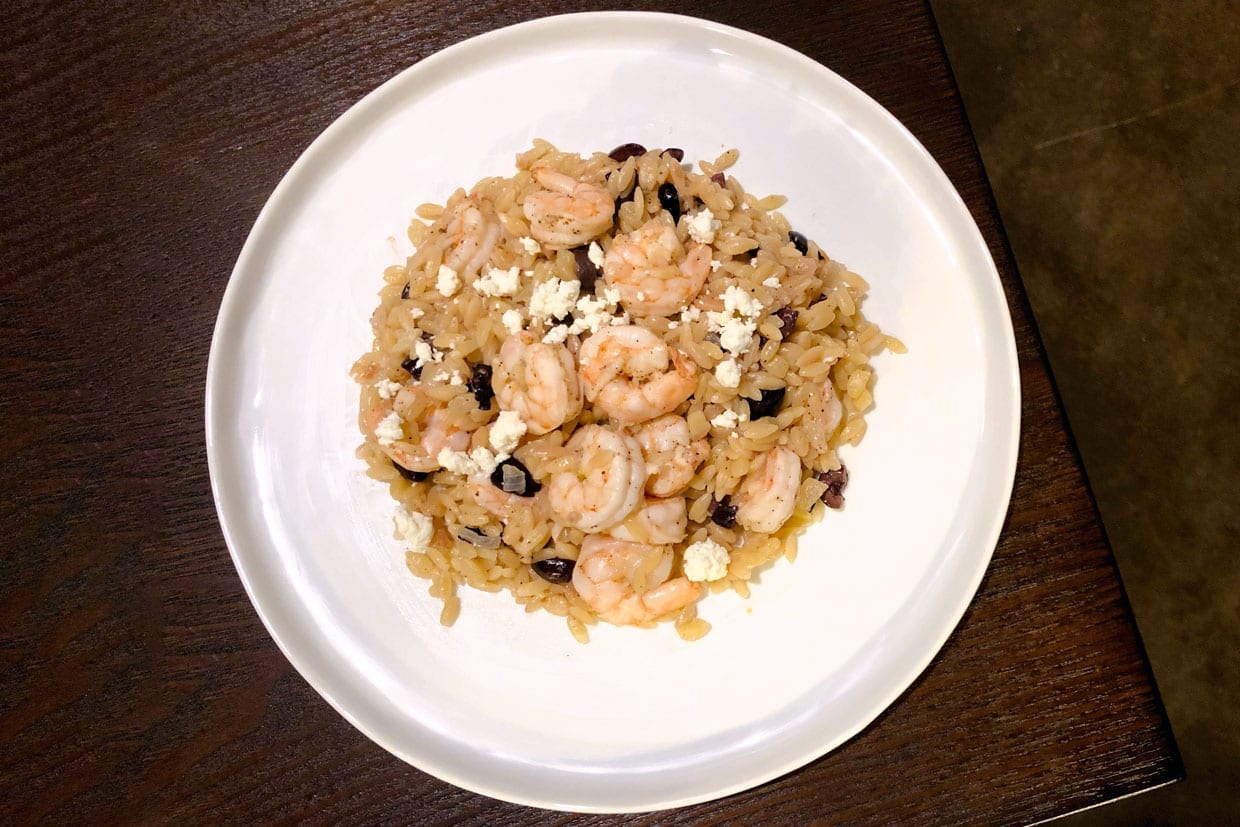 Overhead shot of orzo with shrimp, feta, and lemon.