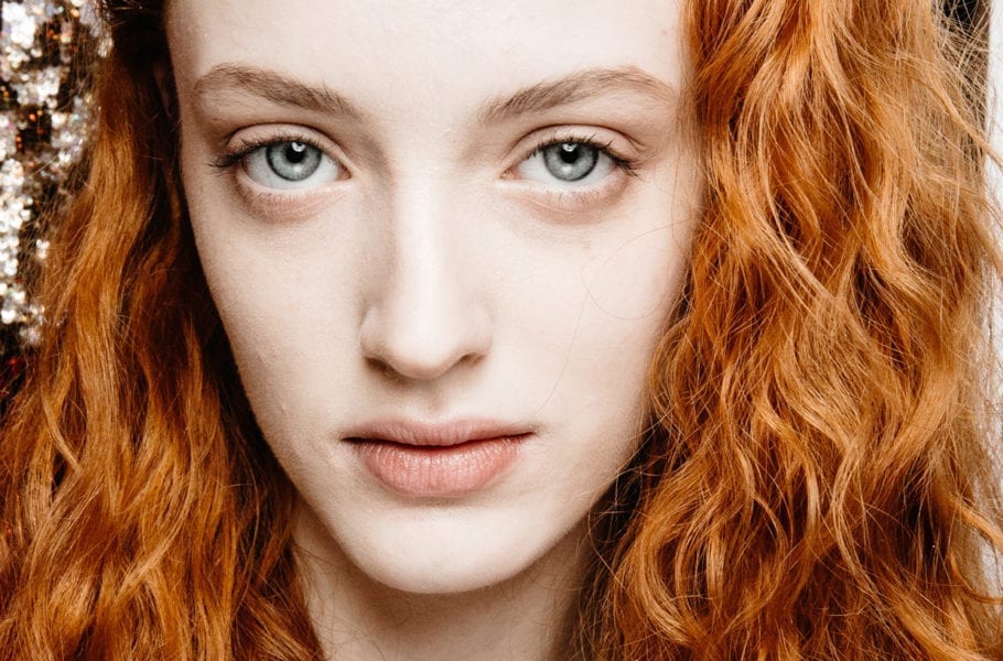 Close up of a young woman with red hair.