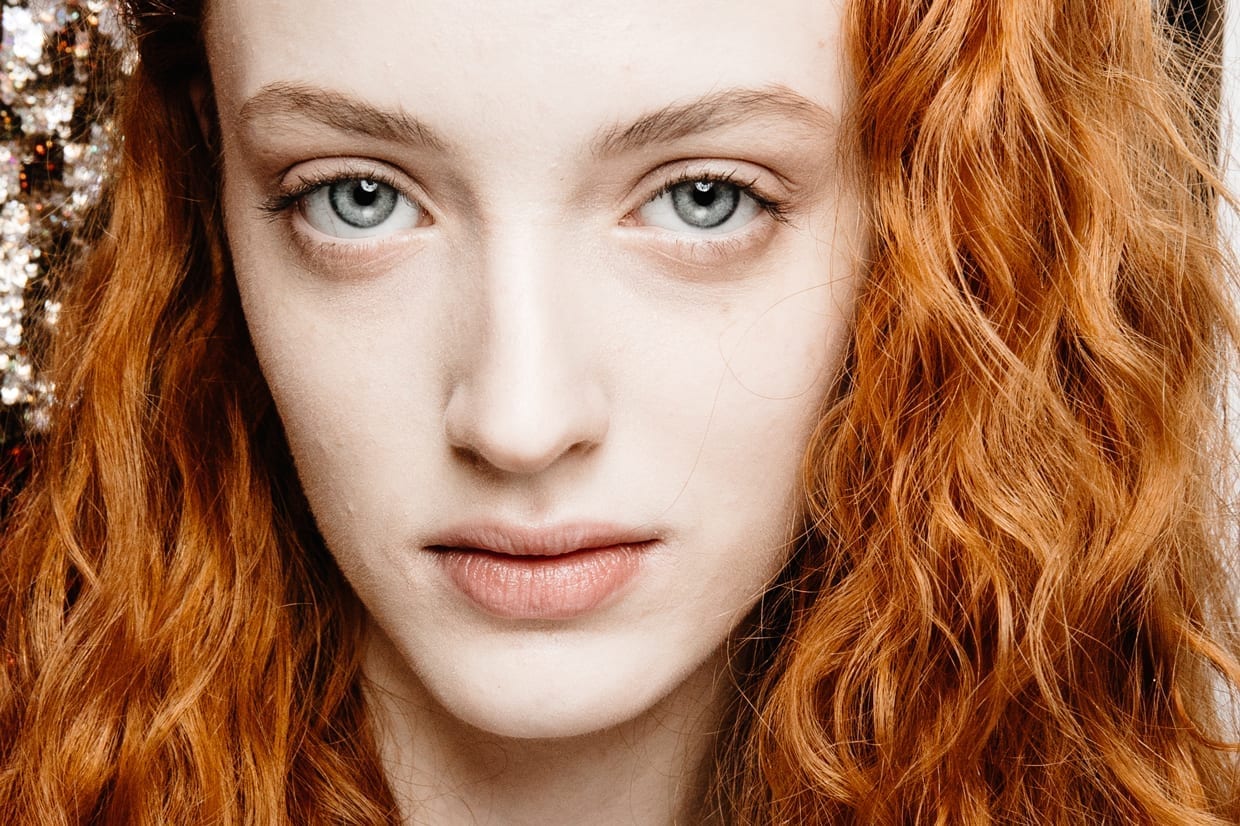 Close up of a young woman with red hair.
