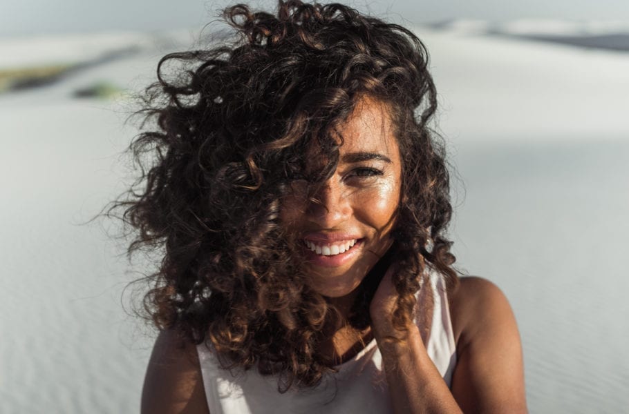 A woman smiling in the desert.