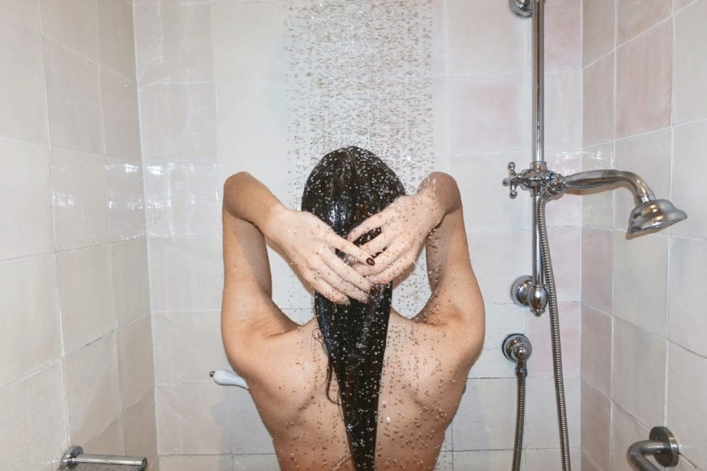 A woman taking a shower.