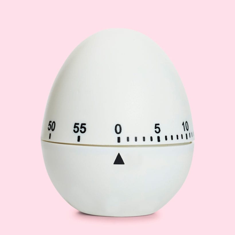 An egg timer on a pink background.