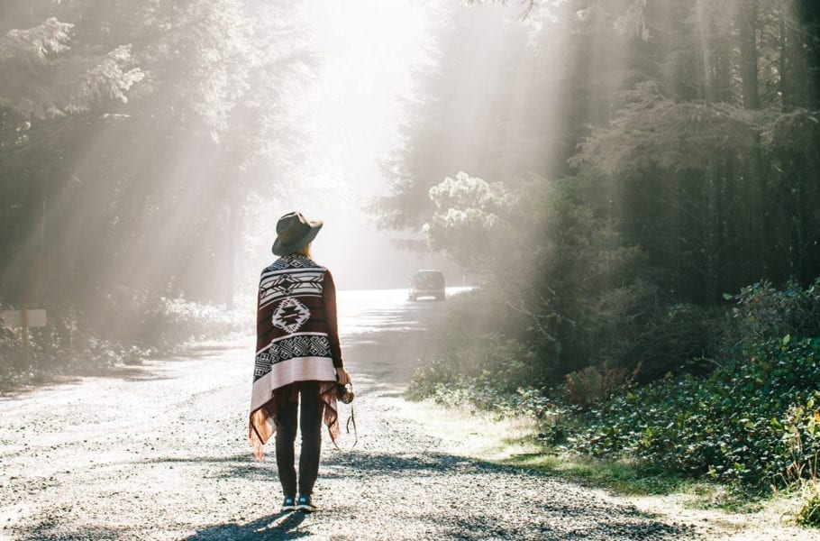 A woman walking in a forest.