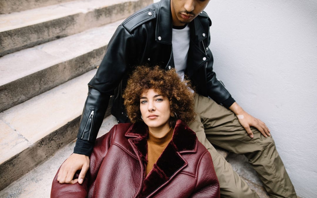 Above view of a woman lying on a man while sitting on street steps.