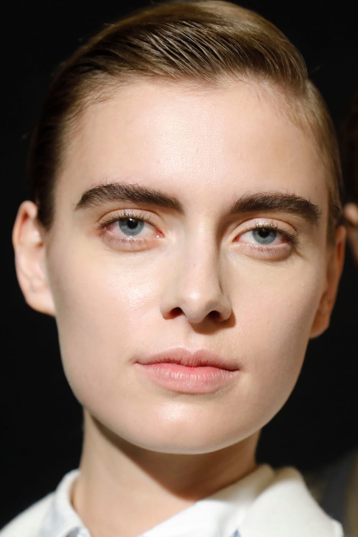 A close up of a woman's face with matte skin.