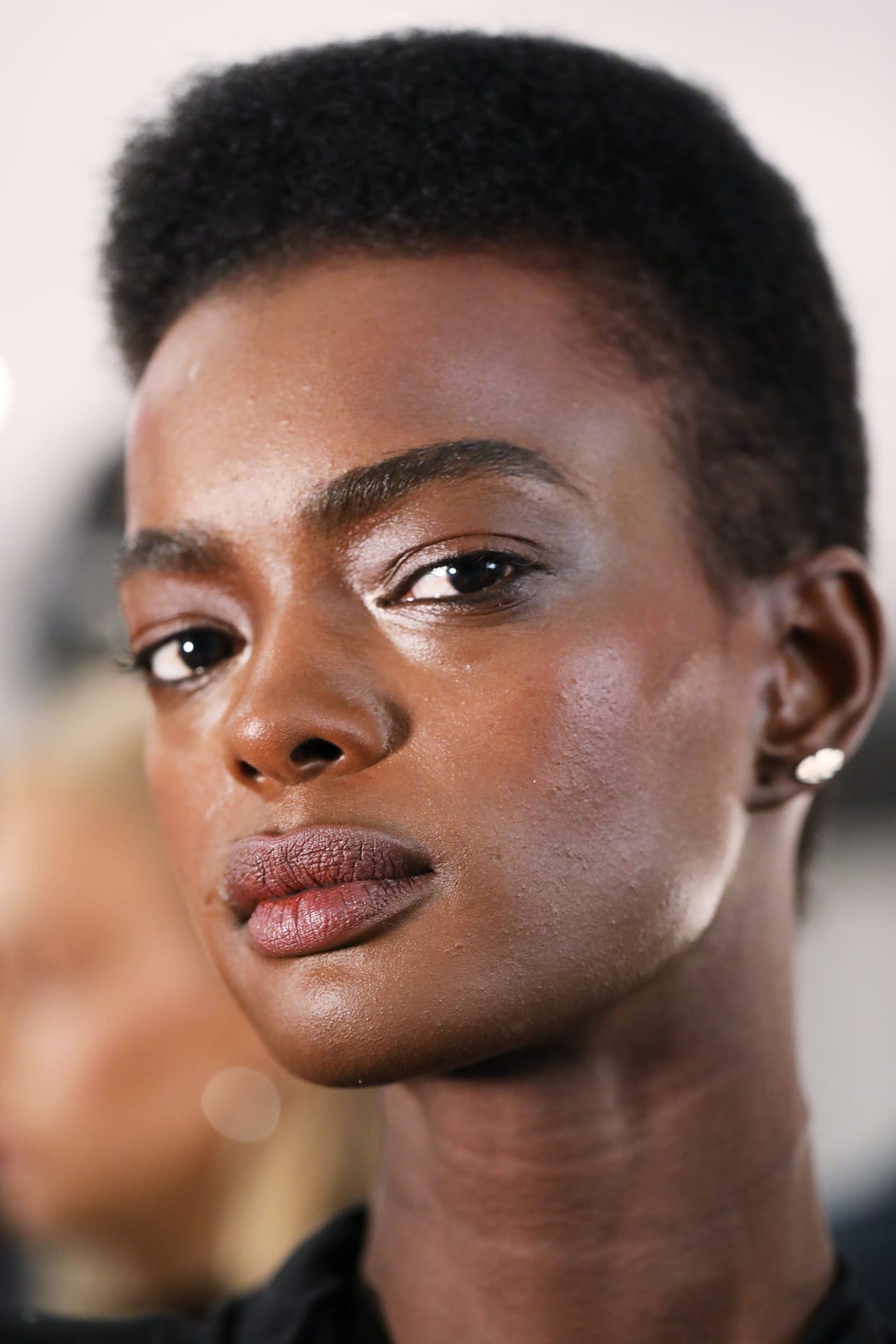 A close up of a woman's face with oily skin.