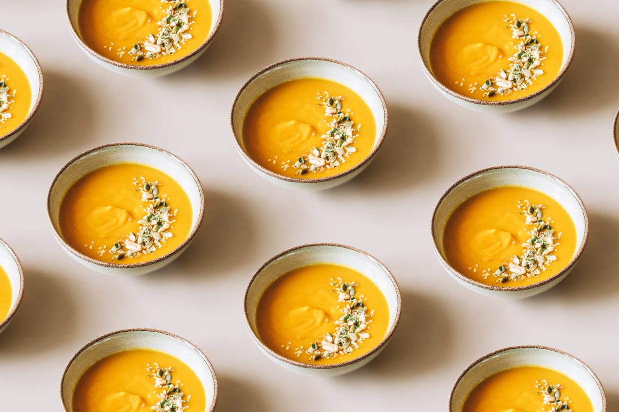 Pumpkin soup topped with herbs, pumpkin seeds and walnuts.