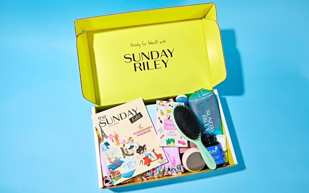 An opened box containing several products on a blue background.