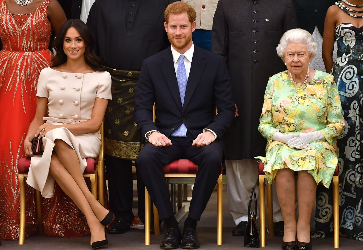 Queen Elizabeth II, Prince Harry, and Meghan Markle at the Queen's Young Leaders Awards Ceremony, Buckingham Palace, London, June 26, 2018.