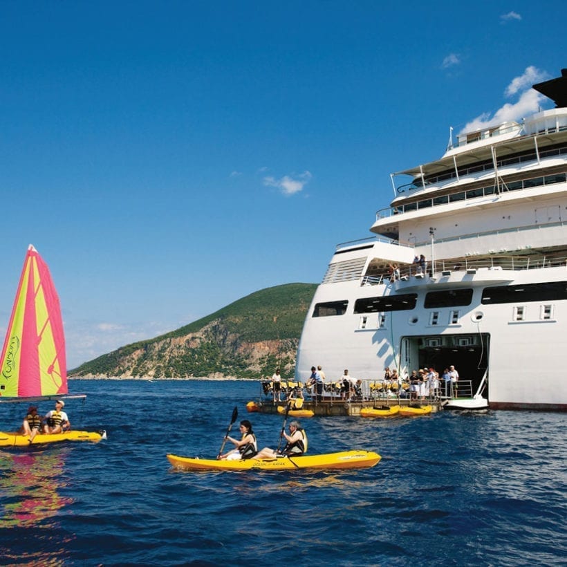 A cruise ship with people on floats.