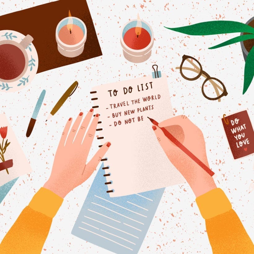 Woman's hands holding pen and writing down goals to achieve in notepad or making to do list.