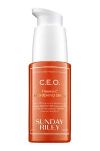 An orange bottle with a white pump.