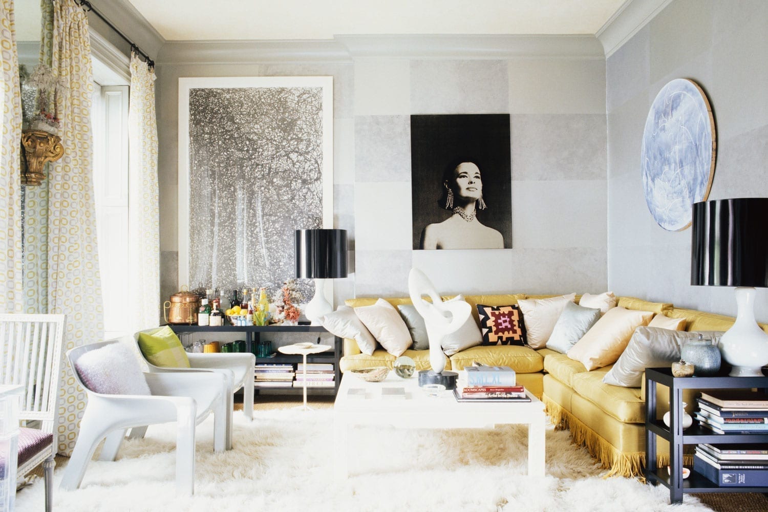 Contemporary living room with paintings, prints, and photos.