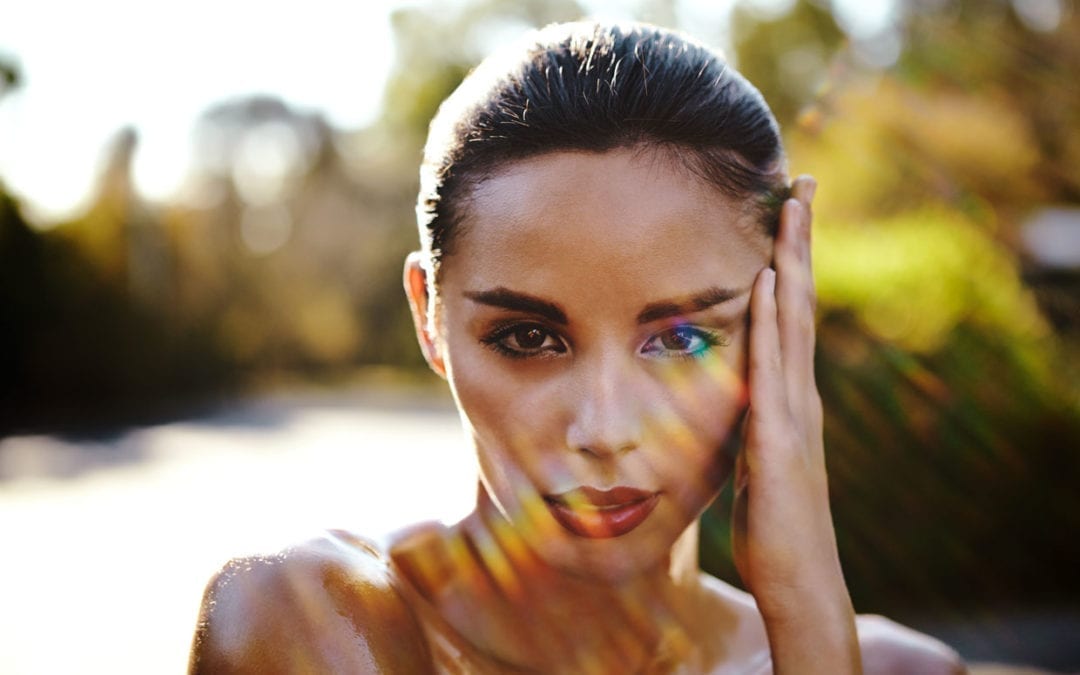 Portrait of a female outside backlit by the sun.