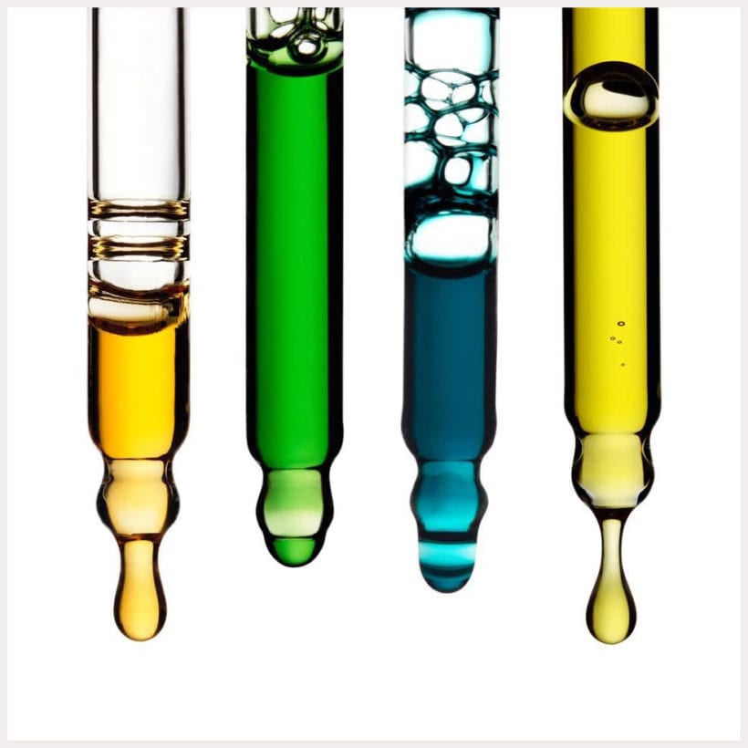 Four droppers each with a different colored oil.