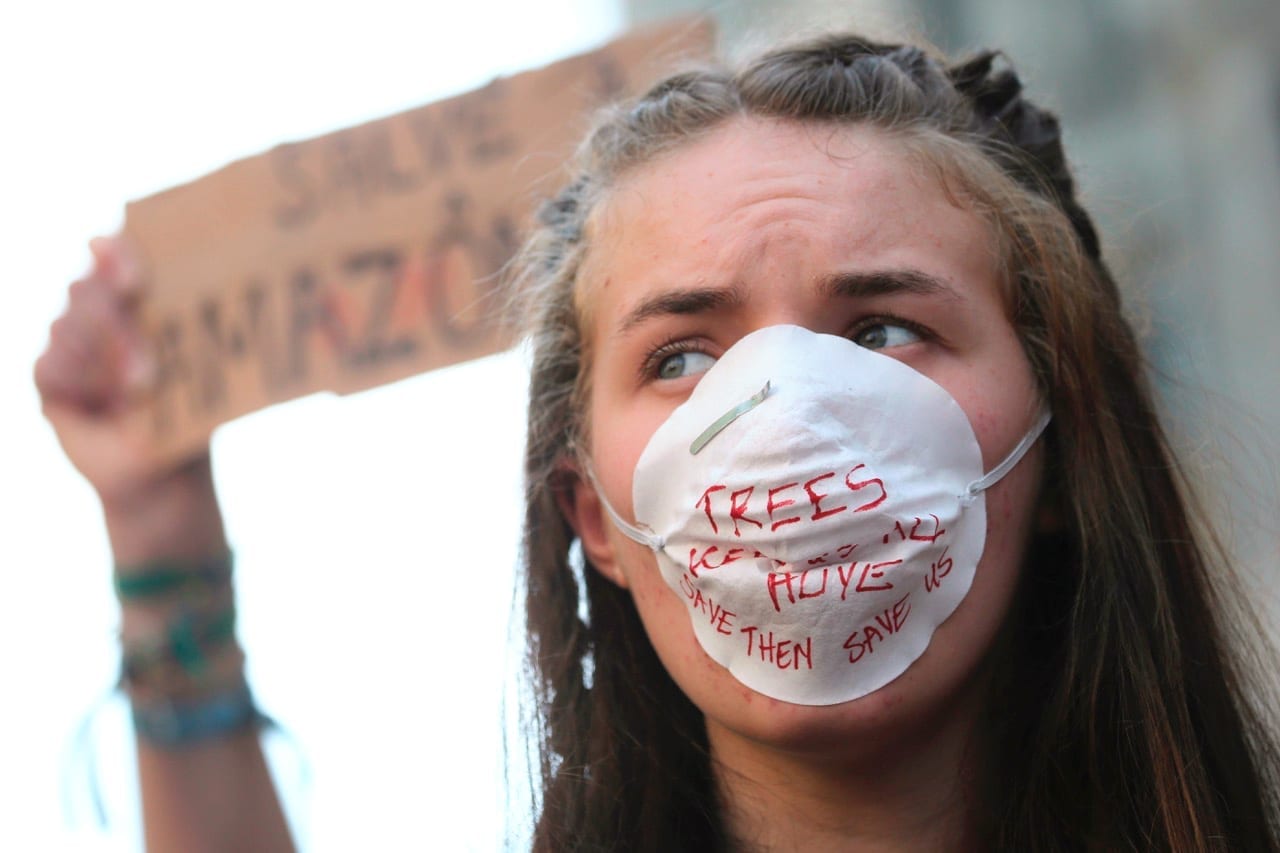 A woman with a face mask at a protest.