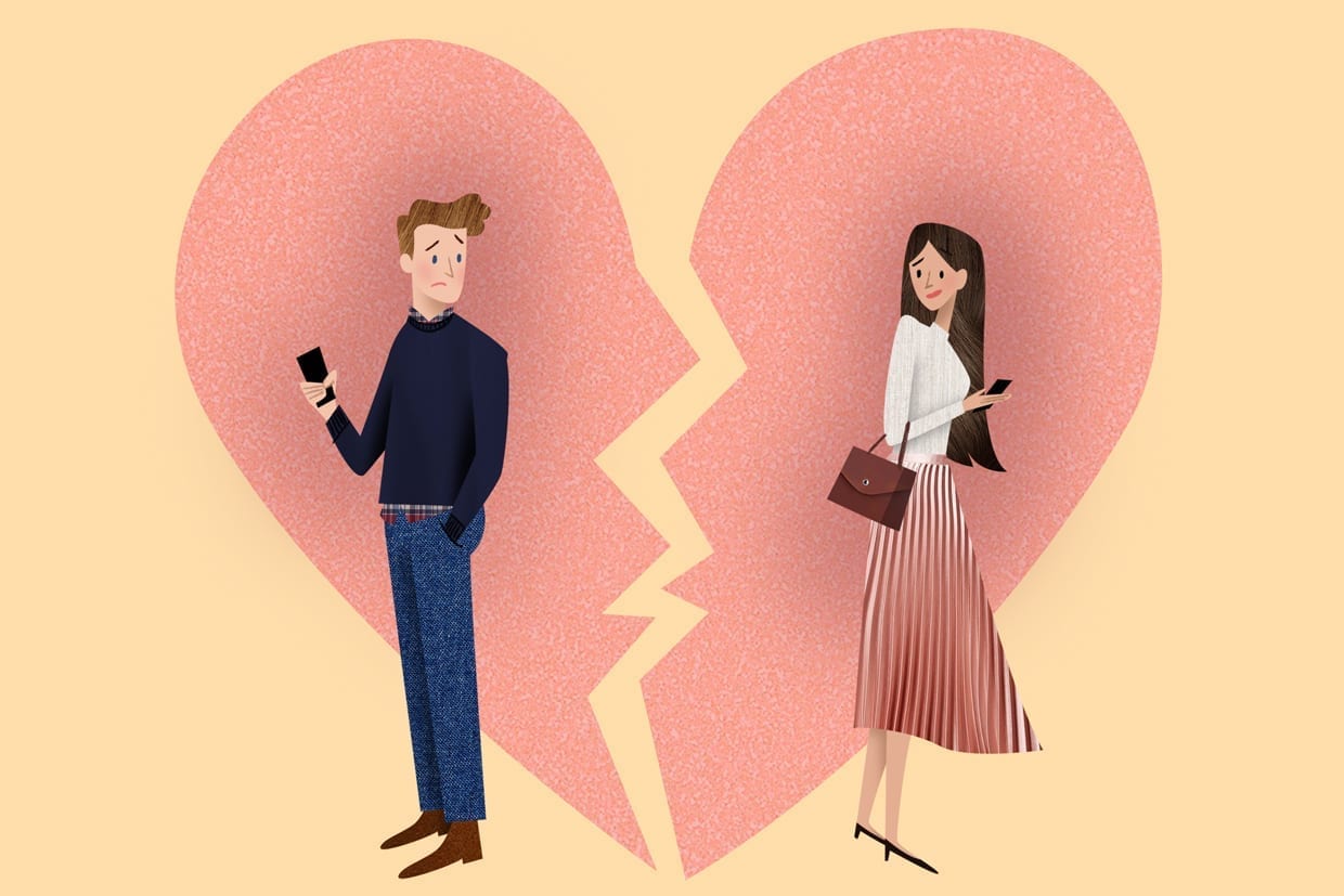 An illustration of a man and a woman holding their phones with their bodies turned away from each other in front of a broken heart.