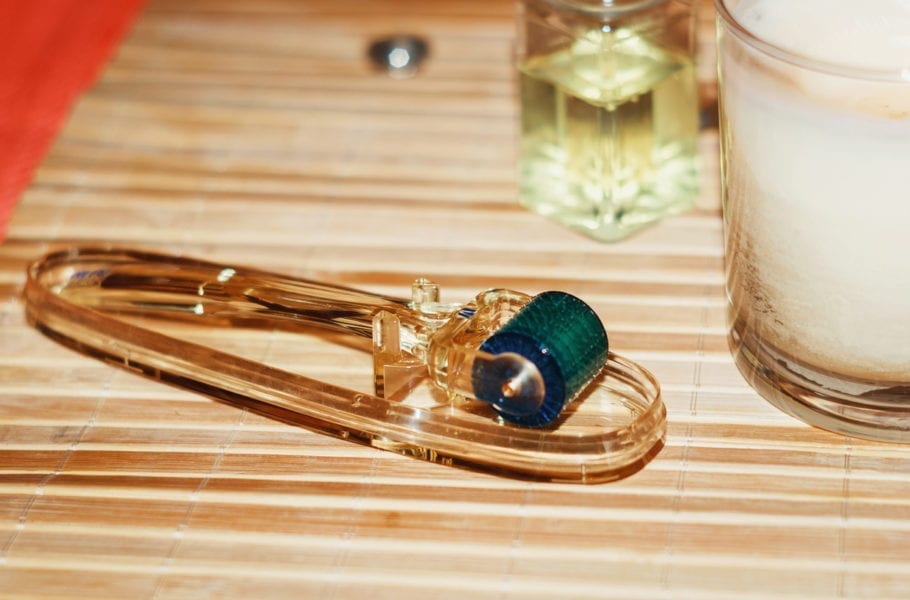 A dermaroller facial device on a wooden countertop.