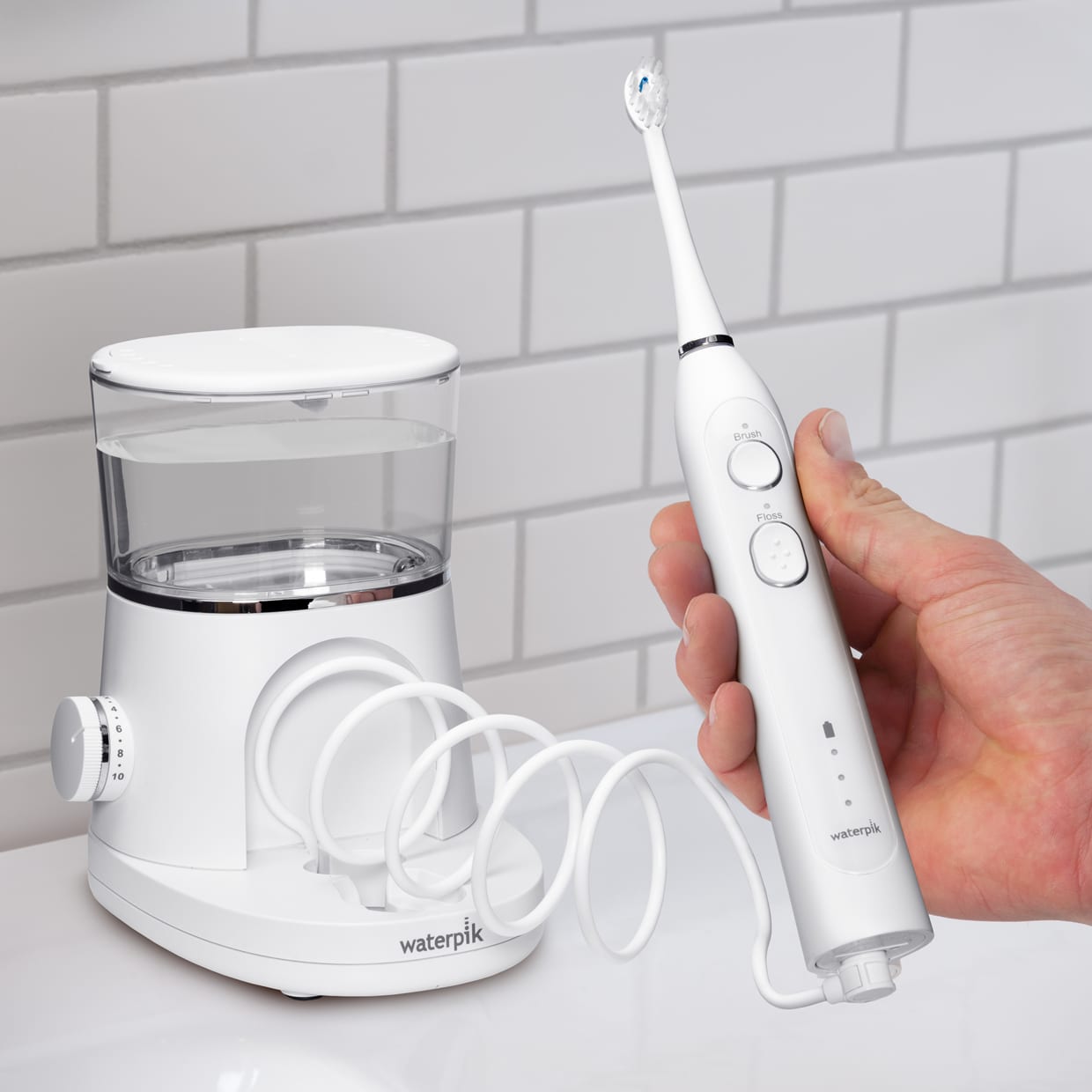 A dual white water flossing and electric toothbrush machine on countertop.