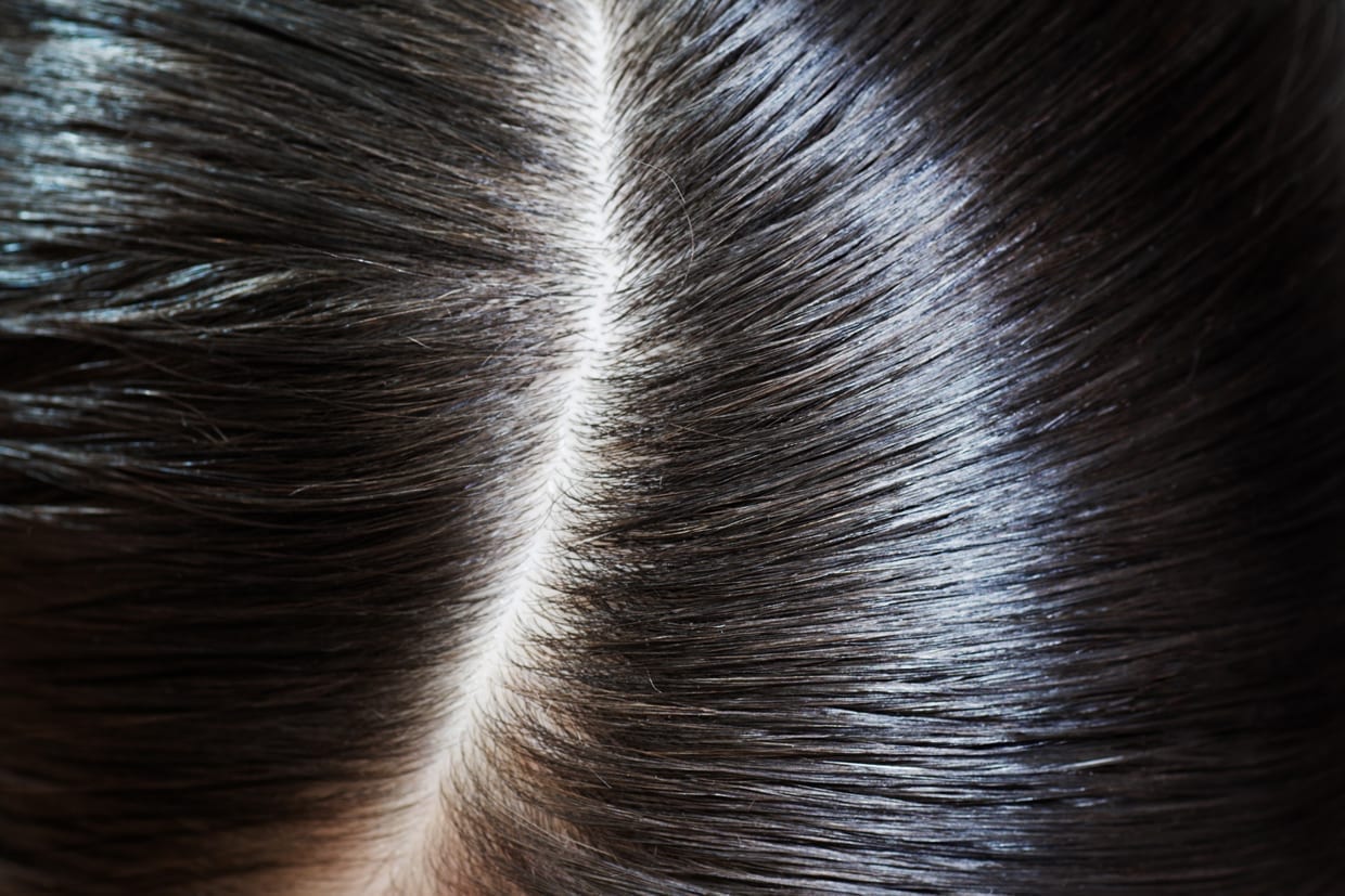 A close up of a hair part.