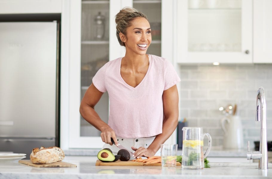 Chontel Duncan cuts up avocado in a kitchen.