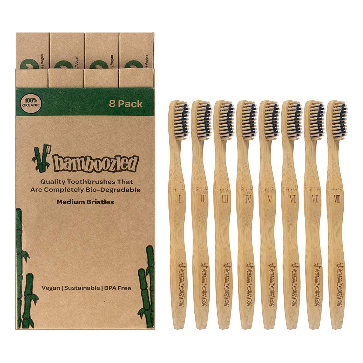 Biodegradable packaging next to bamboo toothbrushes on white.