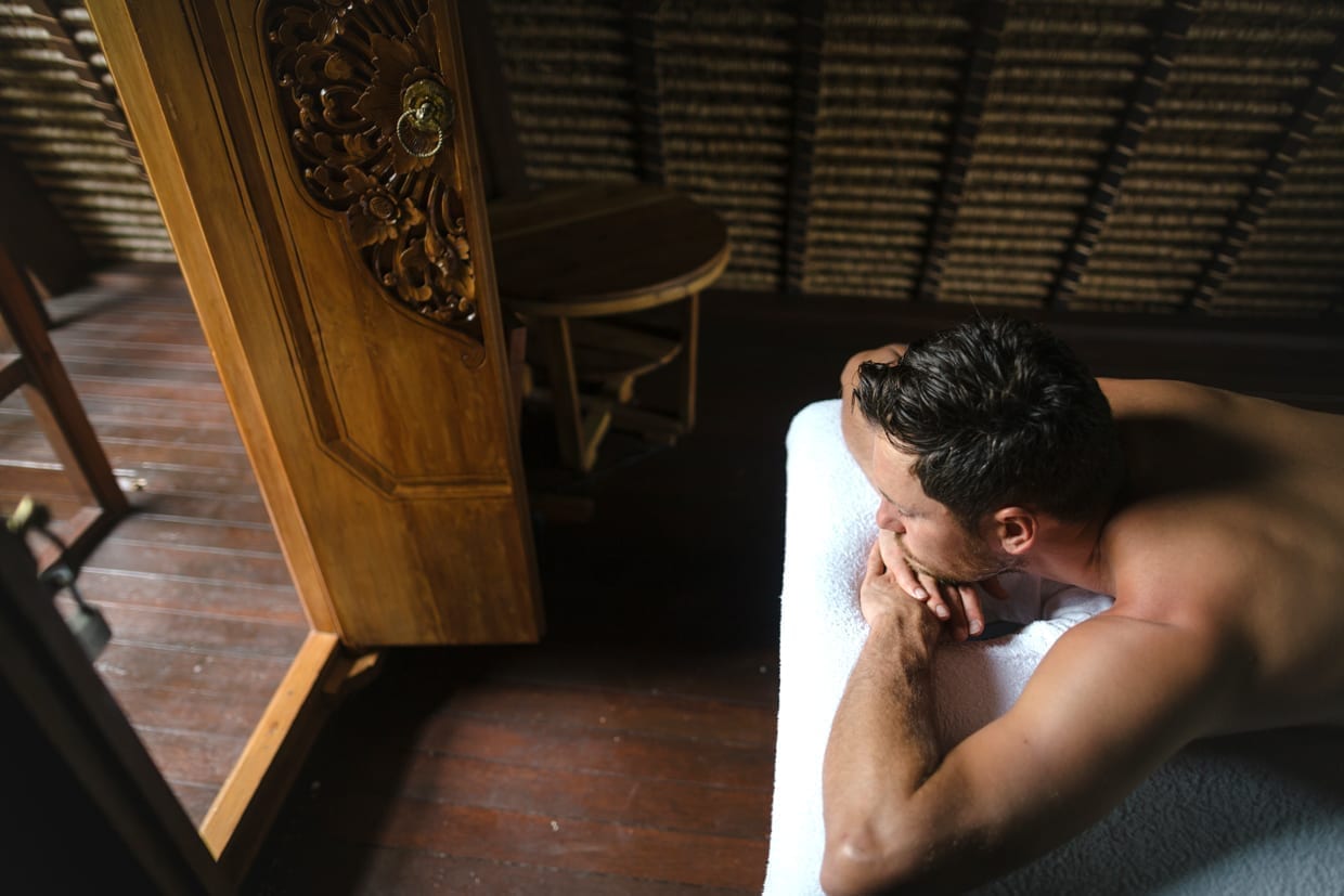 Man receiving a massage at a spa.