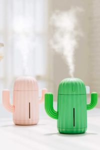 Two cactus shaped humidifiers in pink and green.