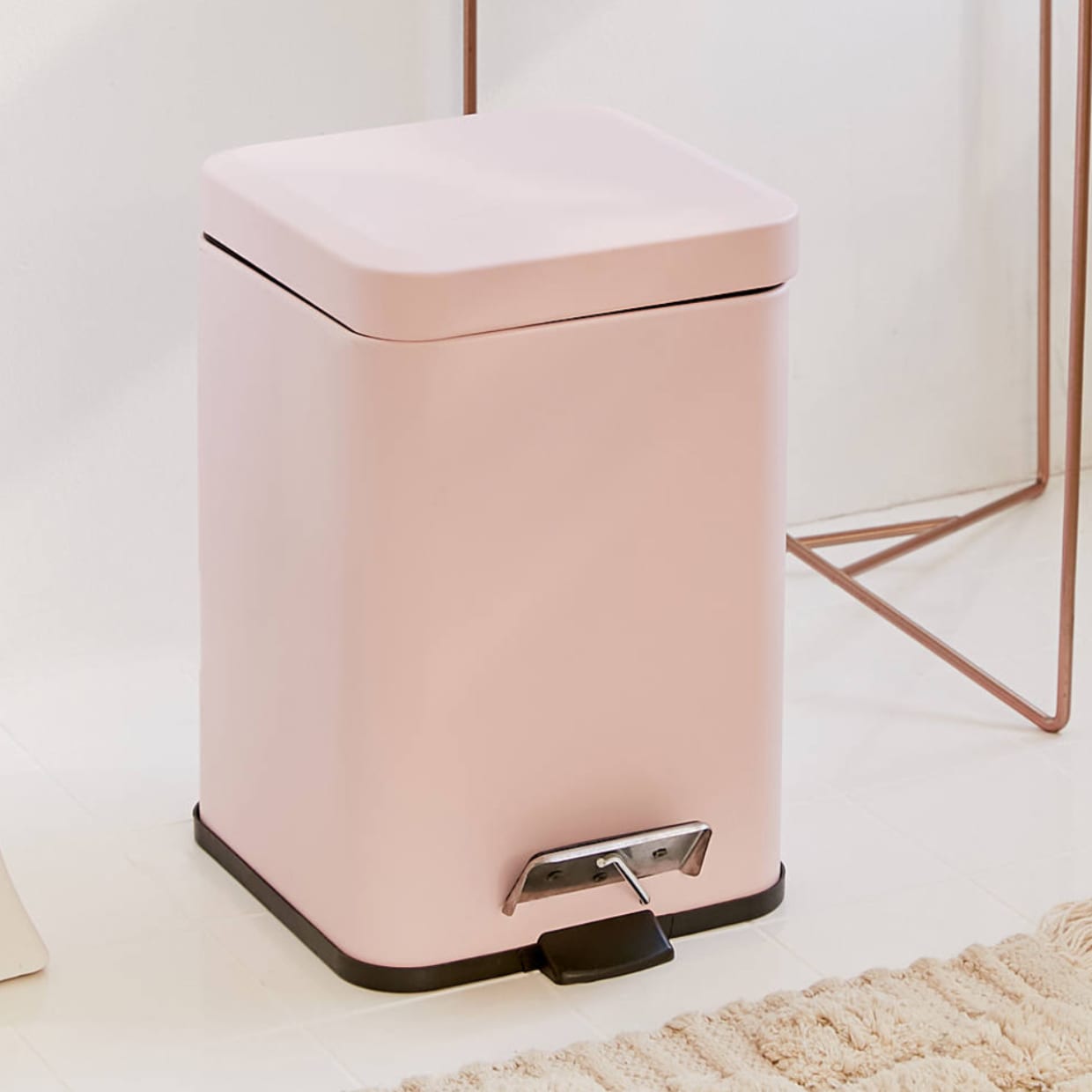 A pink square step trash can.