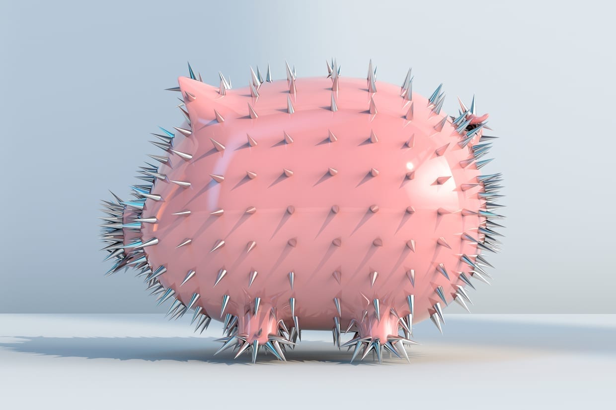 A pink piggy bank with silver spikes.