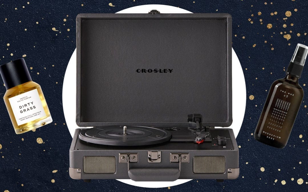 Two bottles with a grey record player in the middle in front of a navy and gold background.