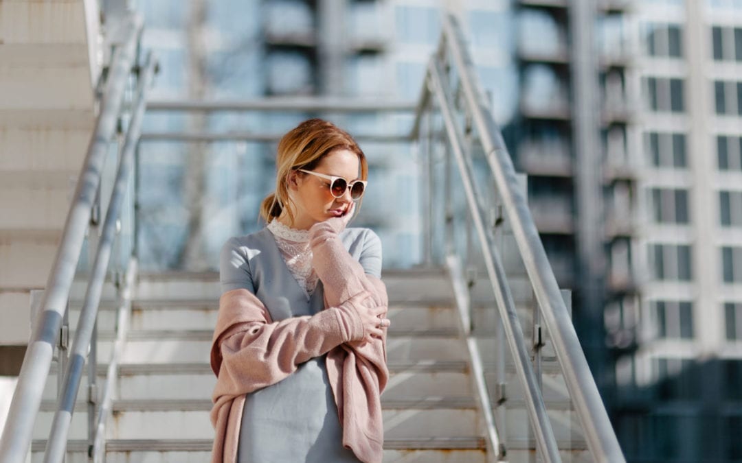 A portrait of a woman on stairs.