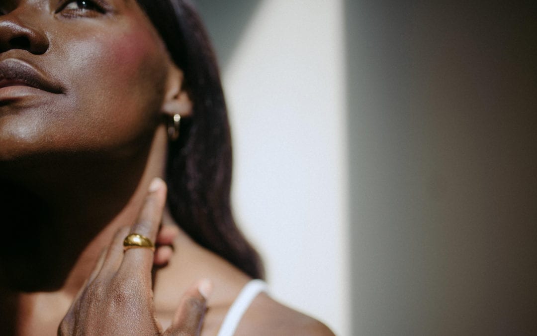 An African-American woman in a close-up natural light portrait.