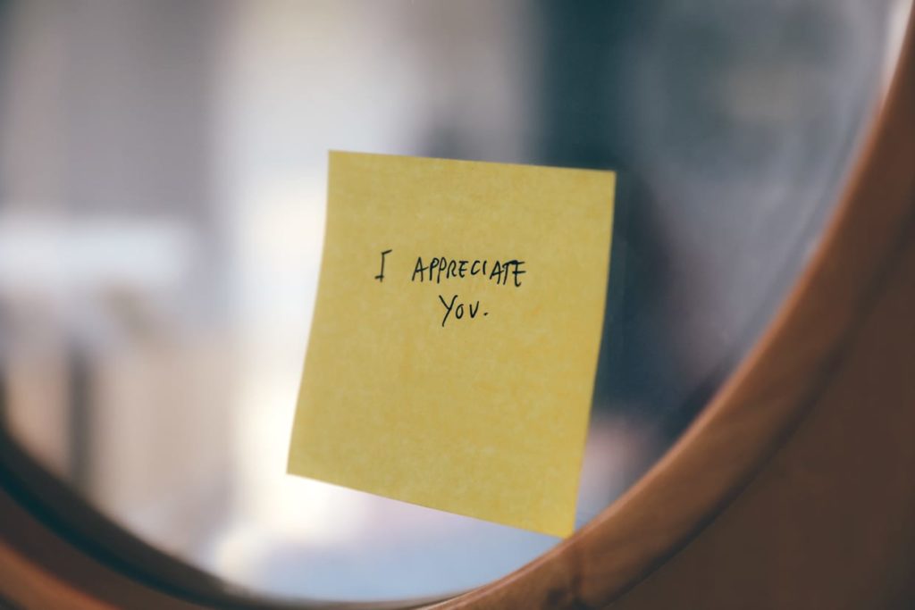 A sticky note on glass that reads, 'I appreciate you.'