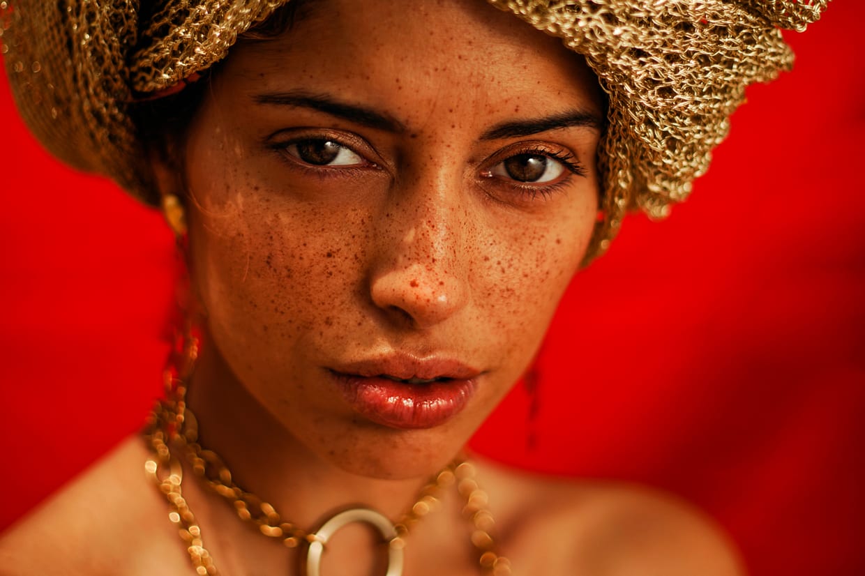 Close up of a woman's freckled face.