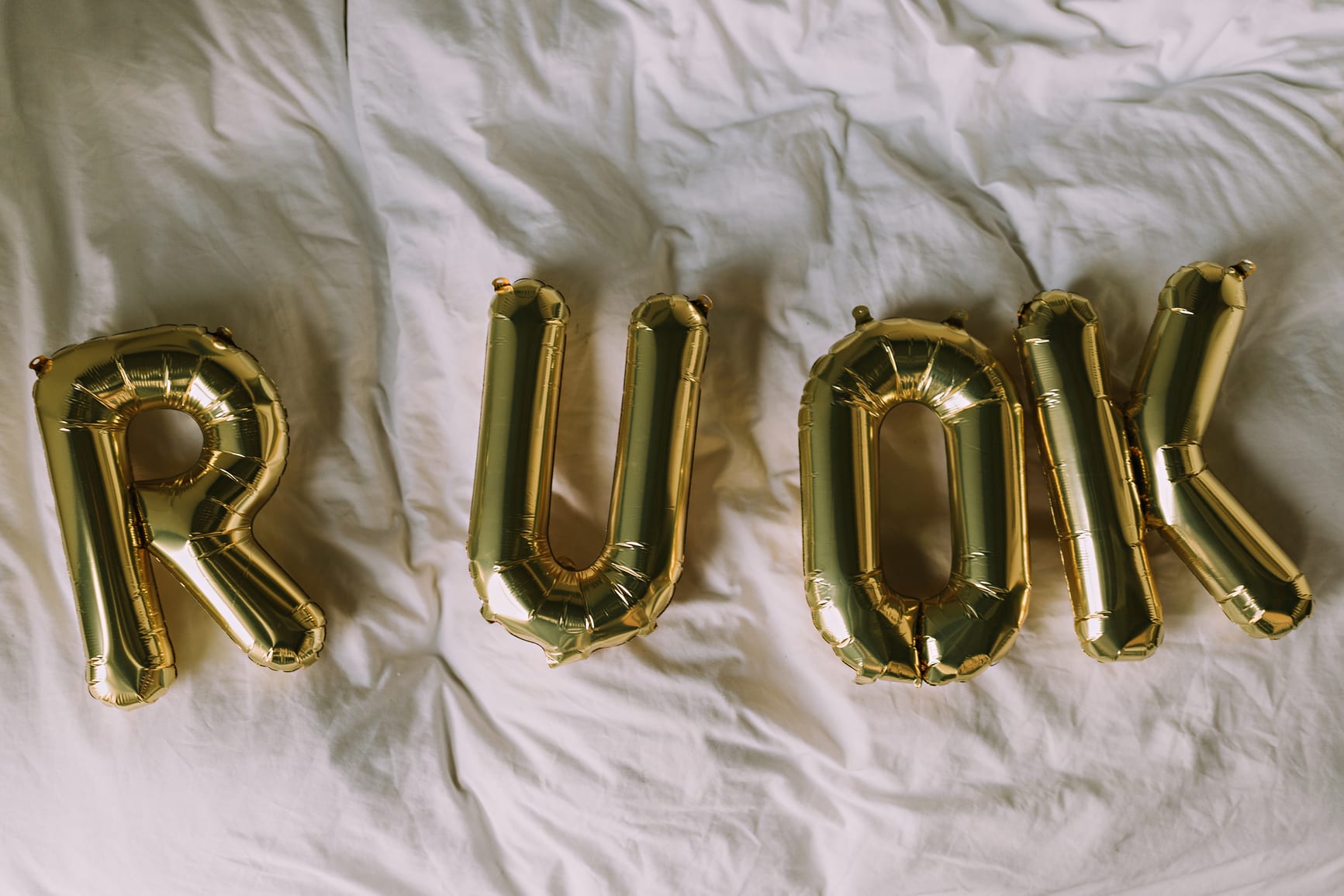 Gold Balloon Letters Ask the Question "Are You Okay?"
