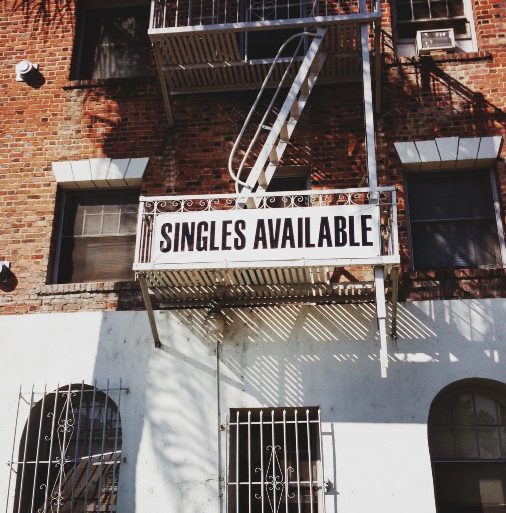 A sing on a building says "Singles Available"