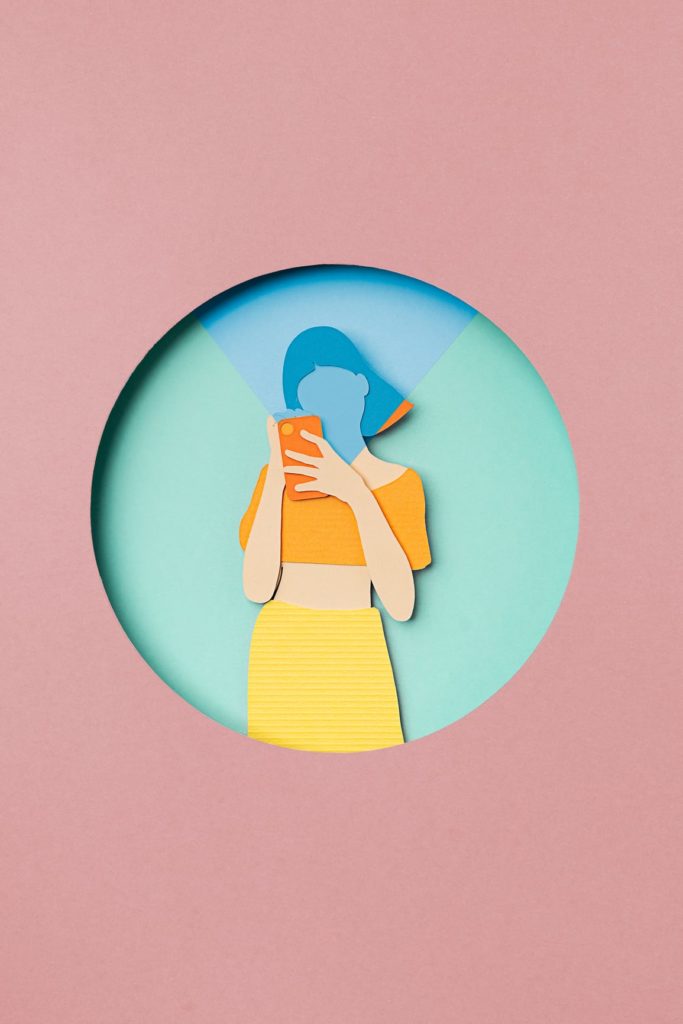Woman inside a circle using a telephone, doing a selfie. Illustration made with paper cutout.